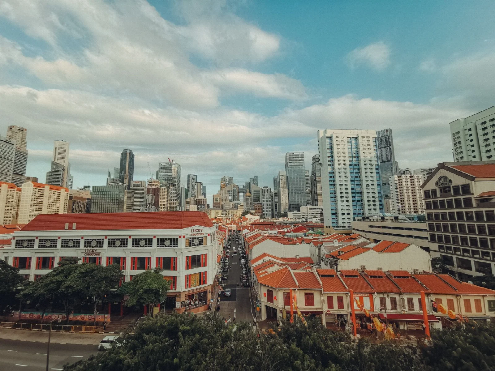 Red rooftops in Singapore’s Chinatown with tall buildings beyond