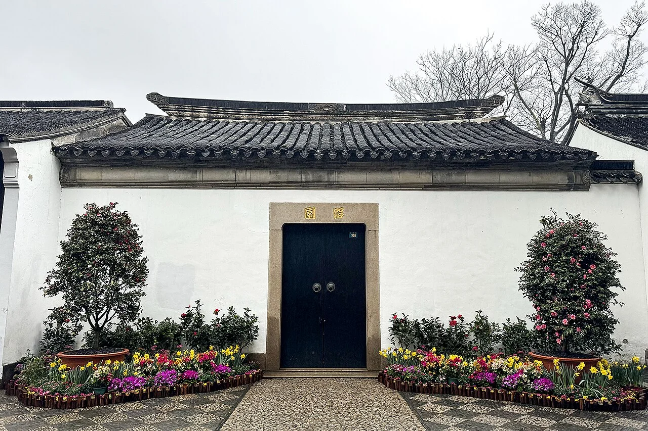 Door and white wall in a Lingering Garden courtyard; Windmemories, 3 February 2024.