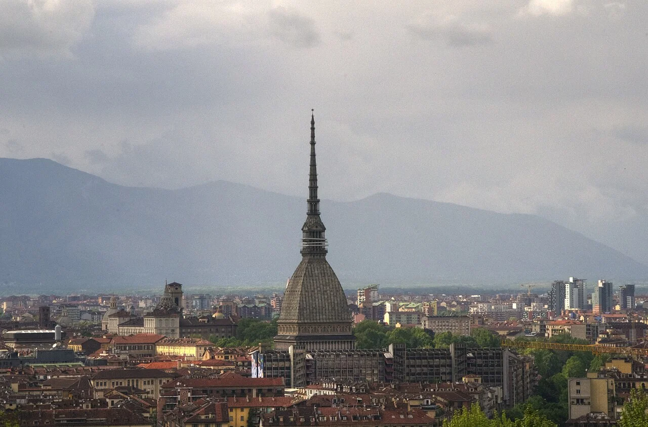 Torino şehir panoramasında Mole Antonelliana ve uzaktaki dağlar; Mayıs 2012, fotoğrafçının tonlanmış görüntüsü.