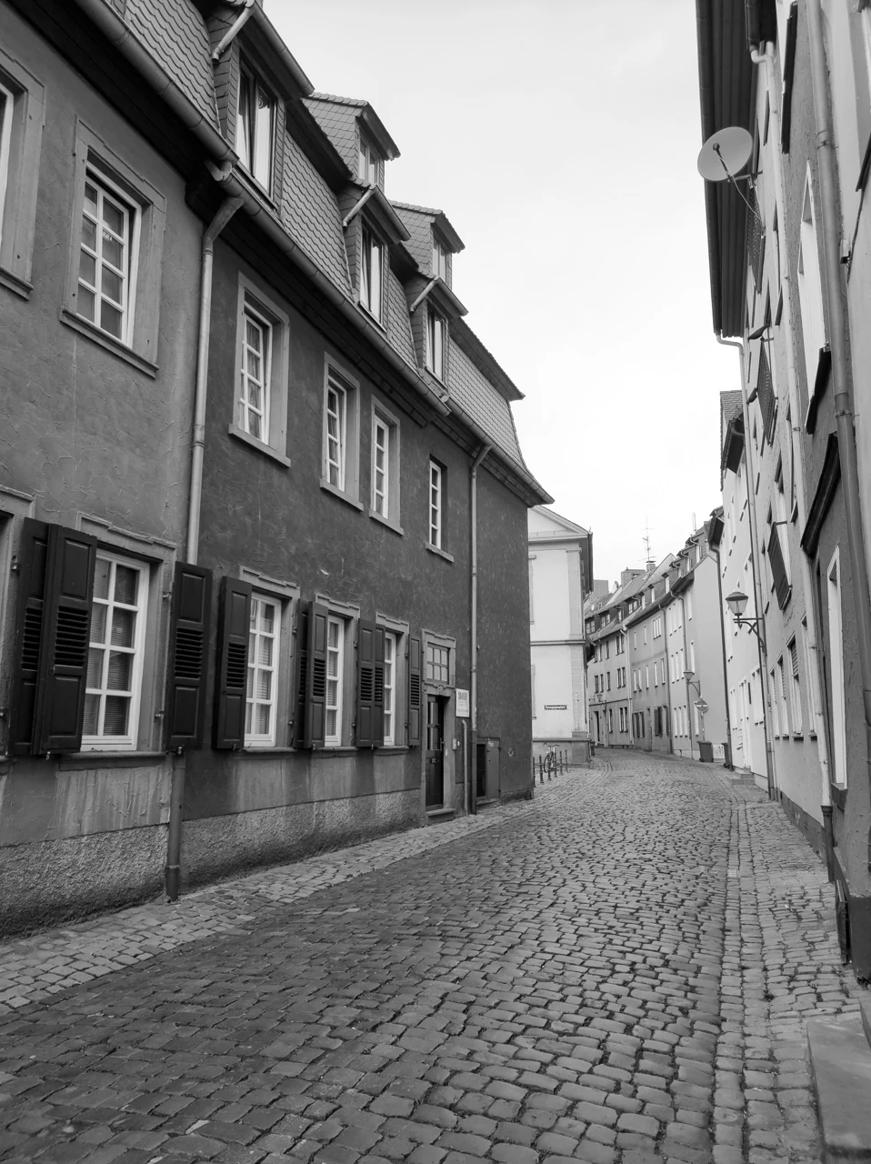 A narrow old-town street in Worms, in black and white